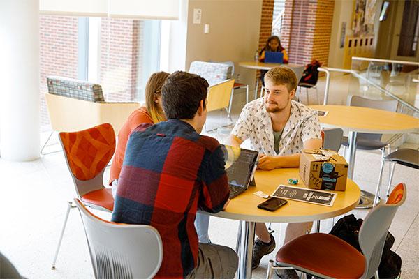 3 students studying in the Gira Center 